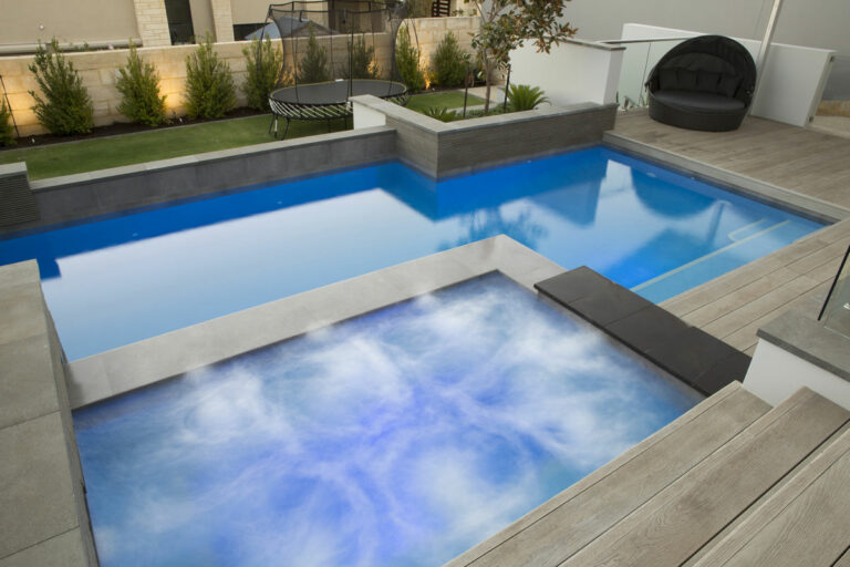 Pool and spa with decking and paving in Perth
